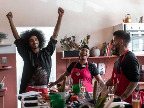 The Nomadic Boys and two cooking teachers at Food Jams having fun in the kitchen.