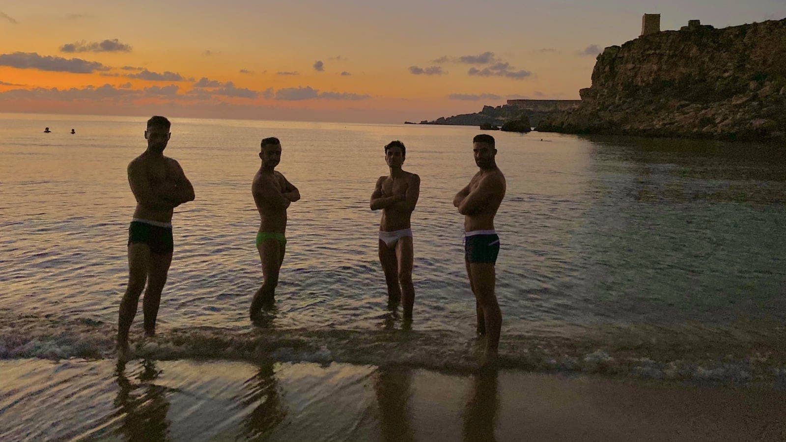 Gay guys posting at the Il Buco gay beach Italy