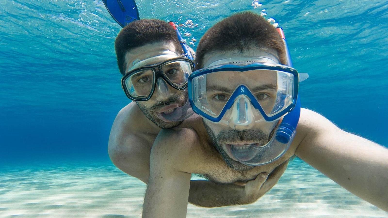 Gay couple snorkeling