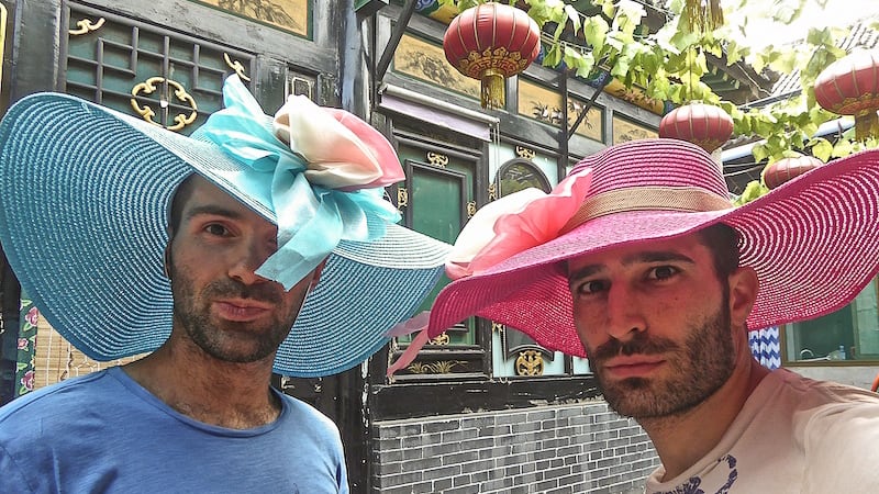 Shopping for Asian inspired hats hats at the Amantis gay shop in Barcelona