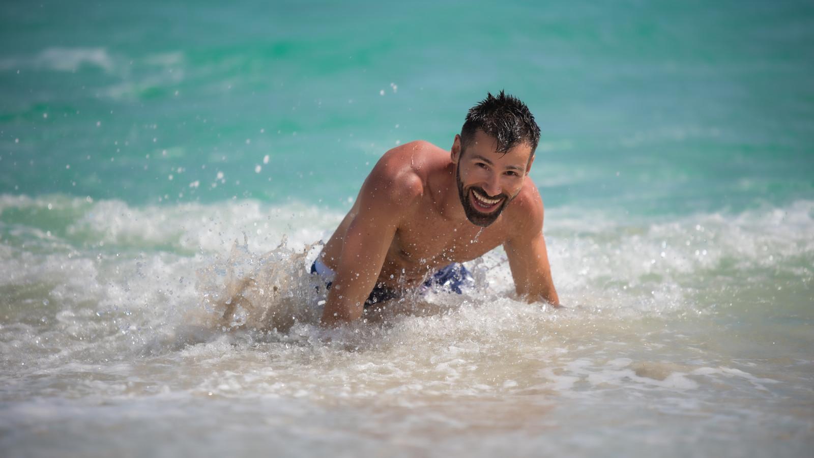 Sebastien from Nomadic Boys playing in the sea in Barcelona