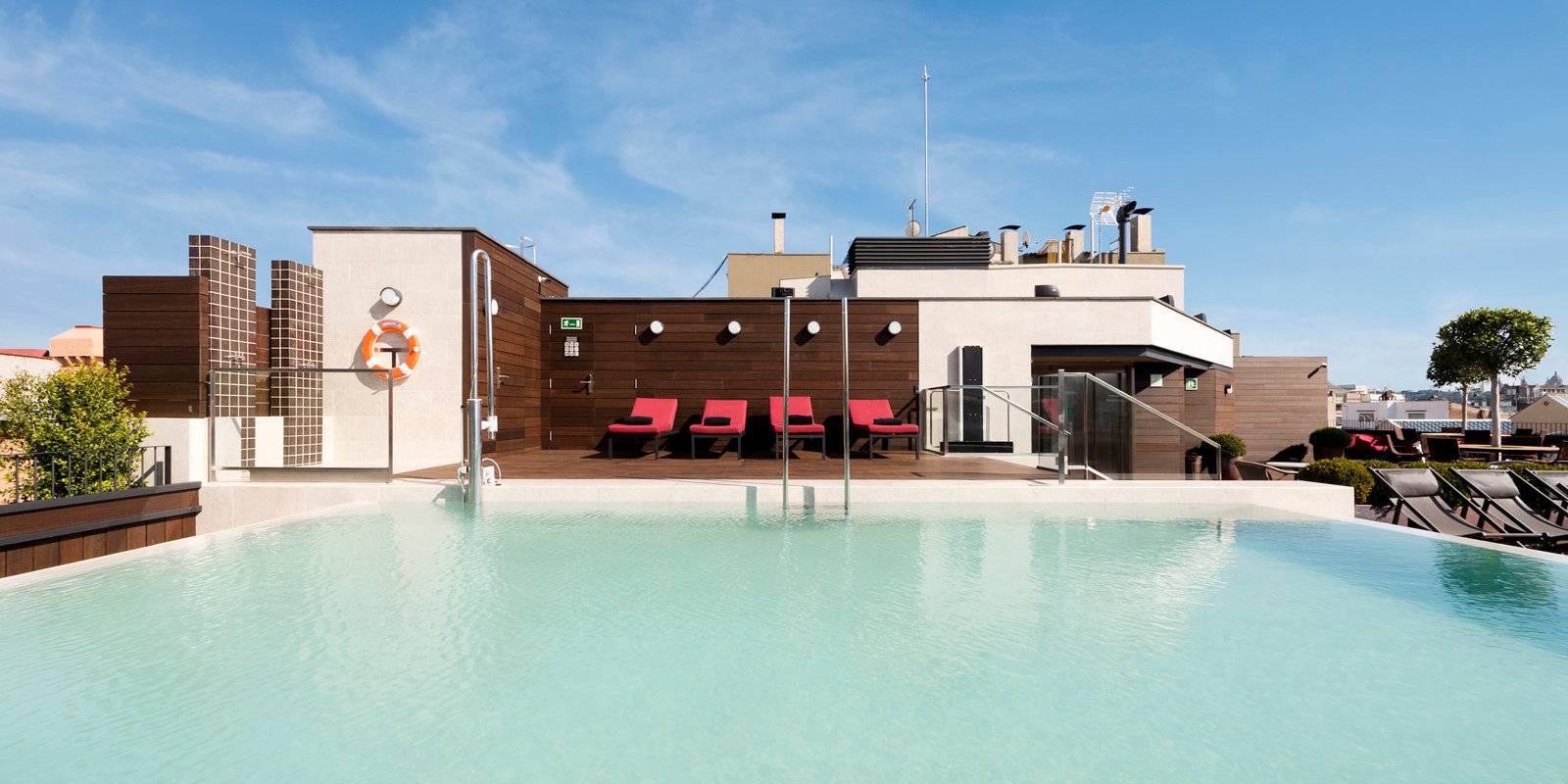 Best gay hotels in Barcelona - the Corner Hotel has a gorgeous rooftop pool and terrace to relax on!