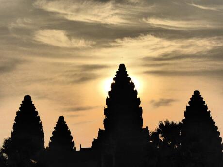 Seeing the sun rise behind the ancient temples of Angkor Wat is an unforgettable experience in Siem Reap