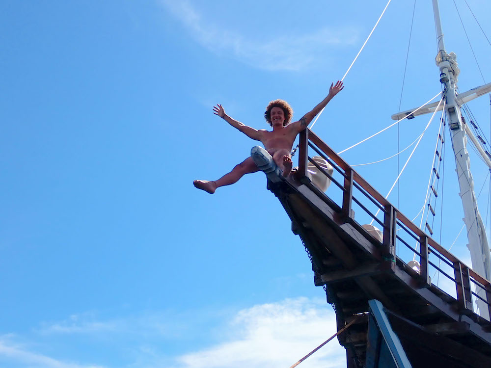 Man on boat sailing on Everything To Sea gay trip.