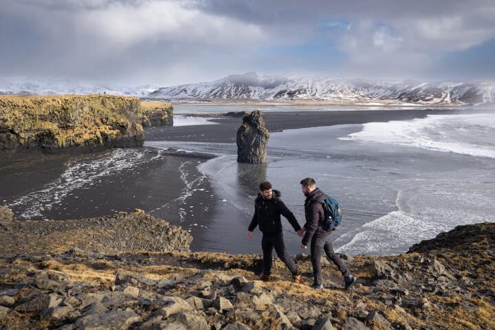 Nomadic Boys walking at the magnificent cliffs near Dyrholaey lighthouse 