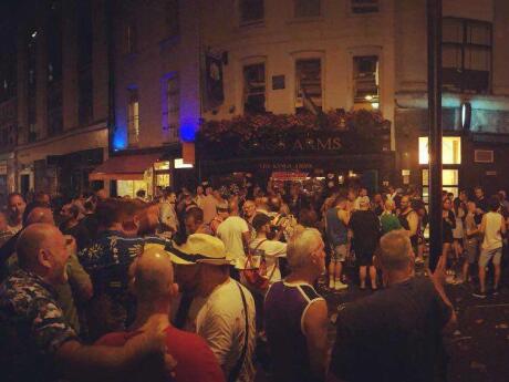 People chatting together at the Kings, one of the oldest gay bars in Soho.