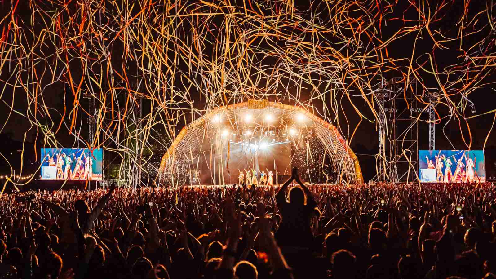 Crowd celebrating at Hoopla at night with singers in the back, an amazing gay music event held in London each June