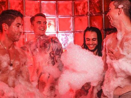 Guys playing together with foam at Sweatbox, a great gay sauna and spa in the heart of London's gay neighborhood.