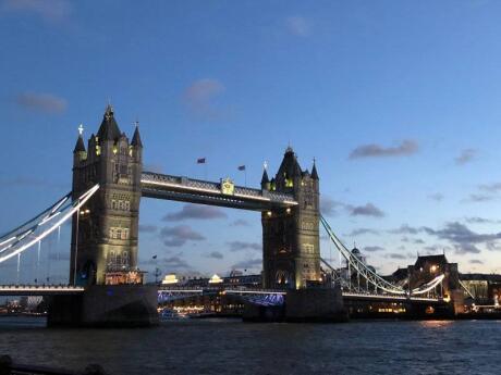 A photo of Tower Bridge at night, all illuminated.