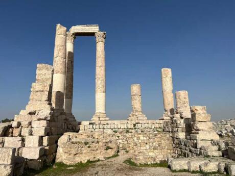 White stone ruins with a blue sky behind from Amman Citadel in Jordan.