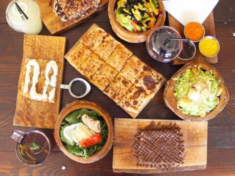 An overhead view of a table filled with delicious Feteer Meshaltet pastries from Fatari in Amman in Jordan.