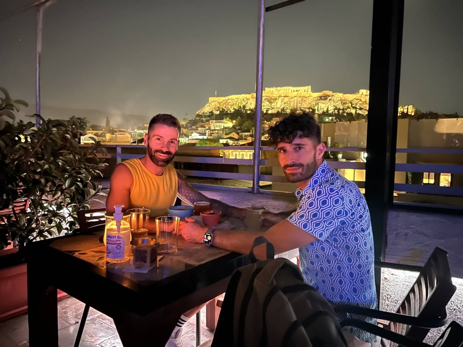 Stef and Seby sharing a romantic cocktail at sunset in Athens.