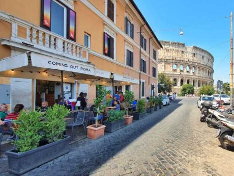 The entrance of Coming Out gay bar in Rome, with the Colosseum at the end of the street!