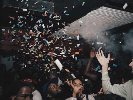 Confetti flying through the air above dancers in a dark room at Great Dane nightclub in Johannesburg.