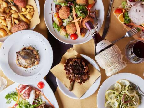 An overhead shot of a table packed with delicious dishes from Pasta e Vino Osteria in Rome.