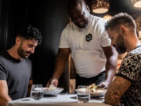 Seby and Stefan being served their meals at the TTK Carbon Restaurant in Johannesburg.